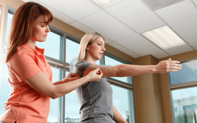 A physiotherapist measures a patient's shoulder range of motion before creating a program of how to increase shoulder range of motion