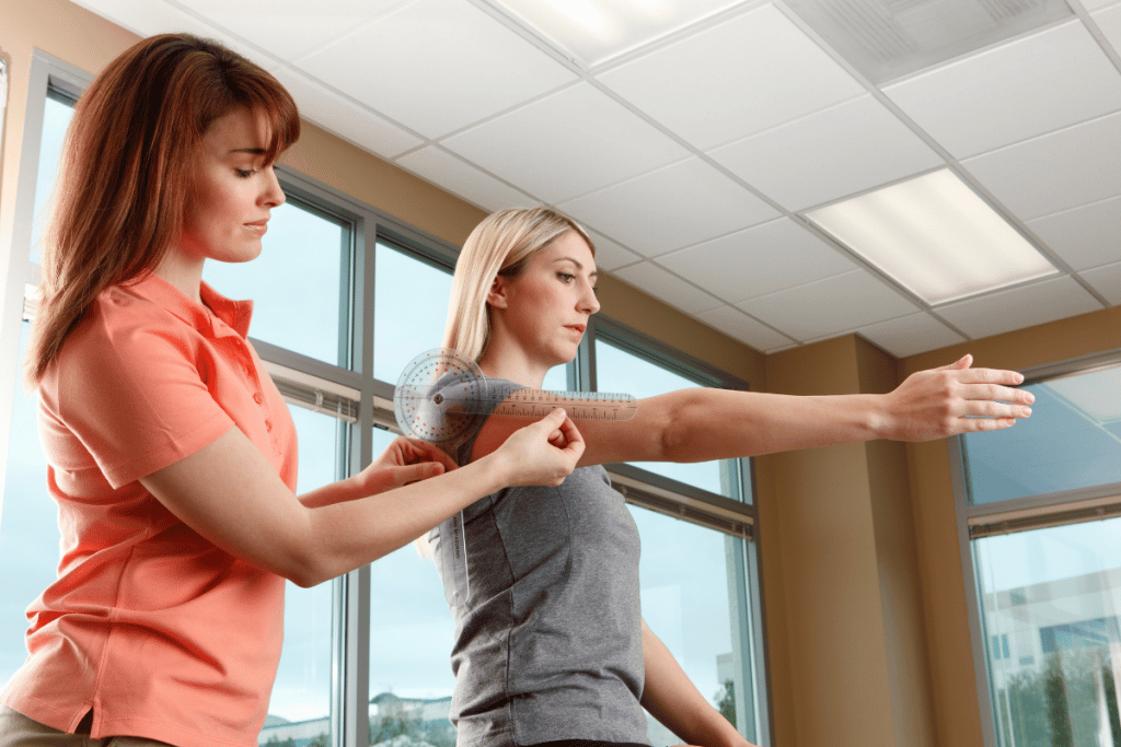 Image shows a physiotherapist measuring range of motion for a patient's flexion using a goniometer.